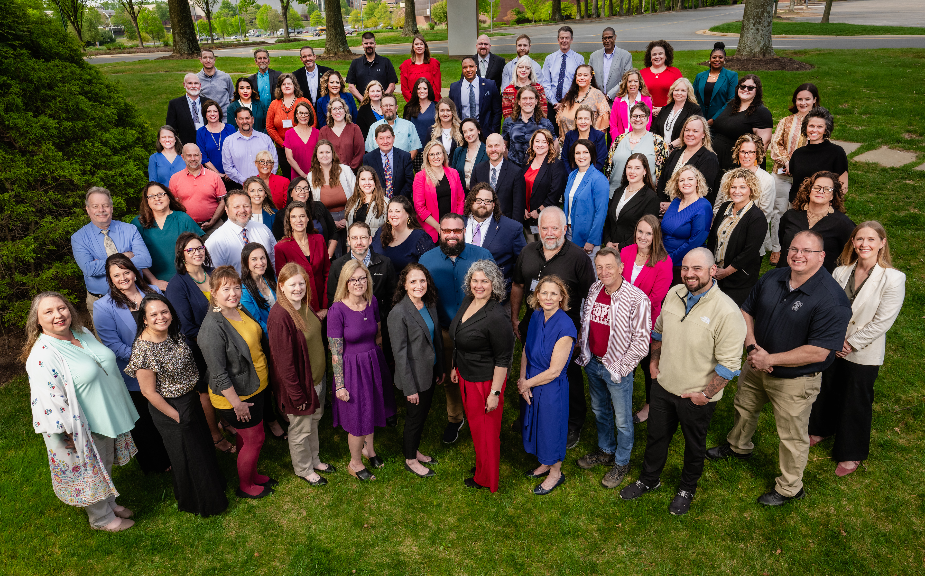 The Reaching Rural Initiative Large group of people standing outdoors on grass near tree