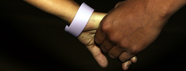 Image of a child and father holding hands