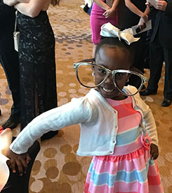 Little girl wearing comically large glasses