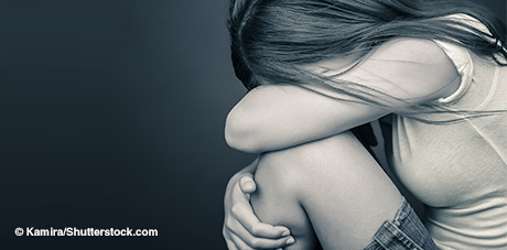Image of young girl with face covered by arms