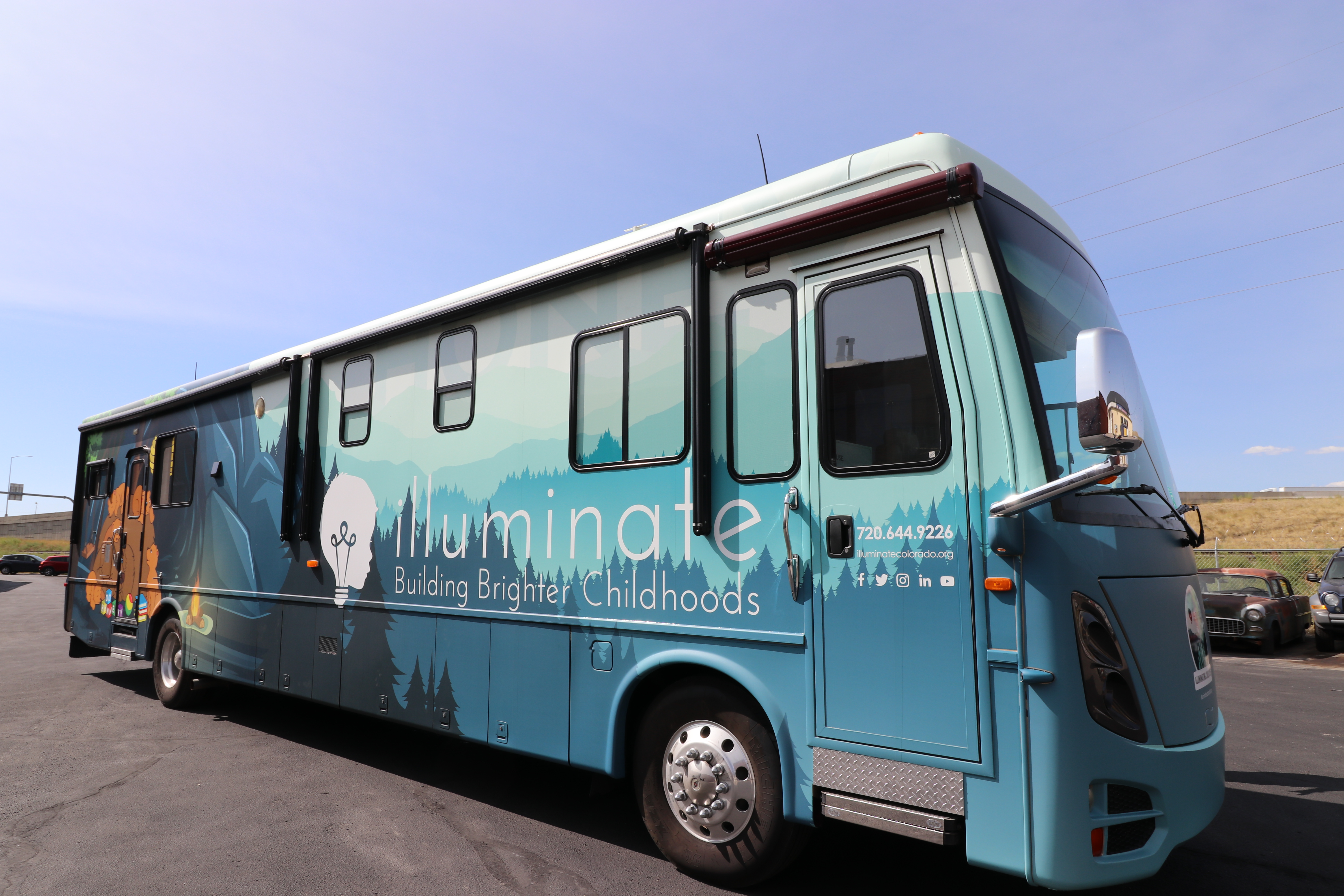 Motorhome RV with text illuminate Building Brighter Childhoods
