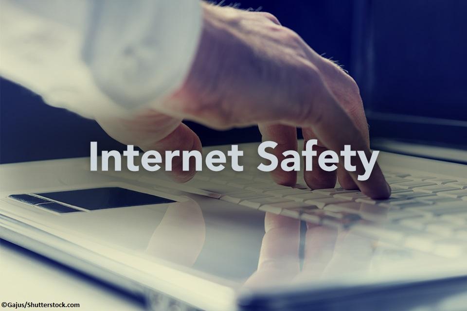 Internet Safety image of hand on laptop keyboard