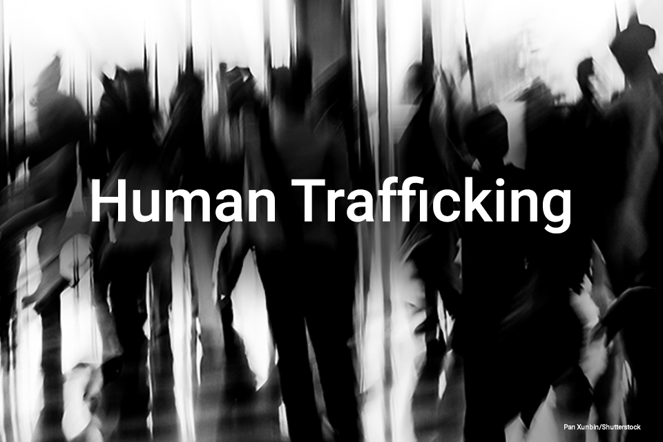 Human Trafficking on background of people walking on street