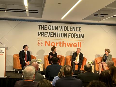 Panel on stage including Amy L. Solomon. Text behind the panel reads, The Gun Violence Prevention Forum.  Northwell.