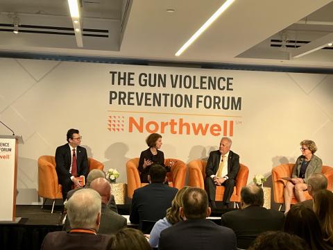 Panel on stage including Amy L. Solomon. Text behind the panel reads, The Gun Violence Prevention Forum.  Northwell.