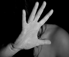 Human trafficking is modern-day slavery outstretched hand hiding woman's face