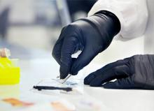 Hand slicing a white blob with a scalpel